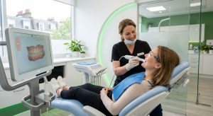 Relaxed patient receiving iTero digital scan from friendly dentist in clean modern clinic